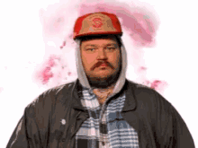a man with a beard wearing a hat and a plaid shirt