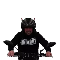 a man wearing a helmet and a rideout shirt