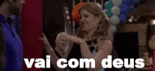 a woman is dancing in a room with balloons and the words vai com deus on the bottom