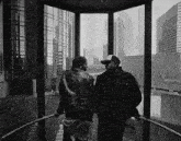 a black and white photo of a man and woman