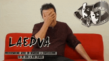 a man sits on a red couch with his hand over his face and the words laedva written on the bottom