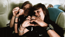 two people making a heart shape with their hands in front of a pzph logo