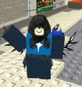 a girl in a blue shirt and black wings is standing on a carpeted floor .