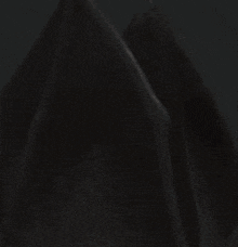 a close up of a demon with flames coming out of his head .