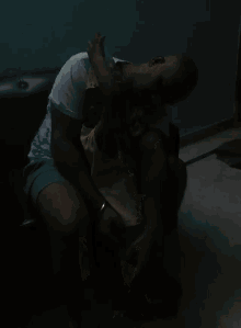 a man is sitting on a couch holding a small child