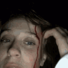 a close up of a person 's face with blood coming out of it .