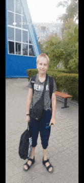 a boy wearing a grey shirt that says deni o.