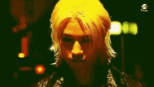 a close up of a person 's face with yellow hair