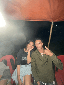 a man and a woman pose for a picture with the man wearing a shirt that says chula