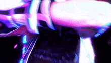 a person is dancing in a dark room with purple lights behind them