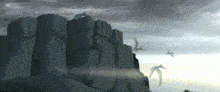 a group of birds flying over a cliff with a cloudy sky in the background