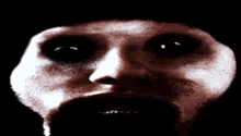 a close up of a person 's face with a black background