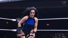 a woman in a wrestling ring with the letters n on the bottom right