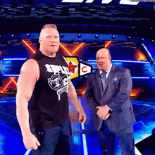 two men standing next to each other with one wearing a shirt that says ' smackdown ' on it