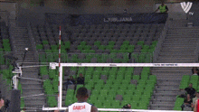 a volleyball game is being played in a stadium with a sign that says do load the volley