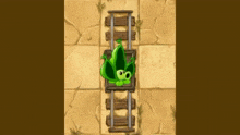 a green plant is laying on top of a wooden train track .