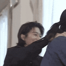 a man in a suit is putting his hand on another man 's neck .