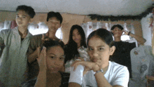a group of young people posing for a picture with one girl wearing a watch
