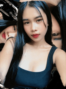 a woman in a black tank top takes a selfie with a reflection of her face
