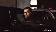a man is getting out of a car with the nbc logo on the bottom