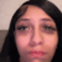 a close up of a woman 's face with her eyes closed .