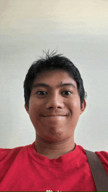 a man wearing a red shirt that says ' aa ' on it