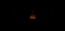 a dark hallway with a few lights on