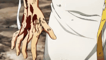 a person 's hand is covered in blood and has a white shirt on