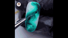 a close up of a nail being painted with a brush
