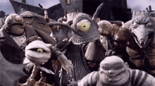 a group of cartoon characters are standing next to each other in a scene from the nightmare before christmas movie .
