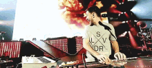 a man playing a keyboard with a shirt that says lv dr