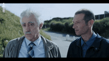 two men are standing next to each other with the letters a and b on the bottom right