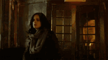 a woman is standing next to a man in front of a building at night .