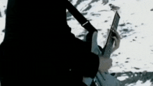a man is playing a guitar in a dark room in the snow .