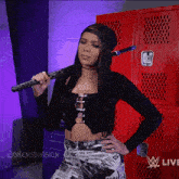 a woman is holding a bat in front of a red locker with the words womens division written on it
