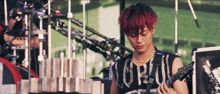 a man with red hair is playing a guitar and wearing a shirt that says ' coral ' on it