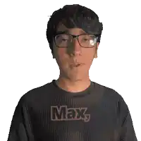 a man wearing glasses and a shirt with the word max on it
