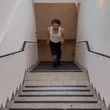 a man is running up a set of stairs in a building .