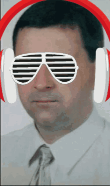 a man wearing headphones and sunglasses looks like he is listening to some music