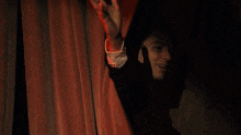 a man in a suit and tie is waving his arm in the air