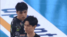 two men are standing next to each other with one wearing a shirt that says ipv on it