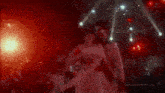 a man is holding a woman in his arms while they are dancing in a disco club .