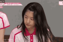 a girl with long hair is wearing a pink and white shirt