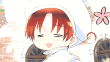 a little boy with red hair and a white hat is smiling