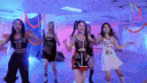 a group of young women are dancing in a room with one wearing a jersey with the number 27 on it