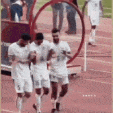 a group of soccer players are standing on a field .