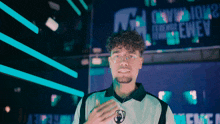 a man wearing glasses stands in front of a sign that says can you tour