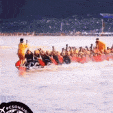 a group of people are rowing a boat in the water with a pesonair logo on the bottom right