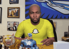 a man in a yellow shirt with a snapchat logo on it