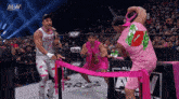 a wrestler in a pink shirt with a kiss on it